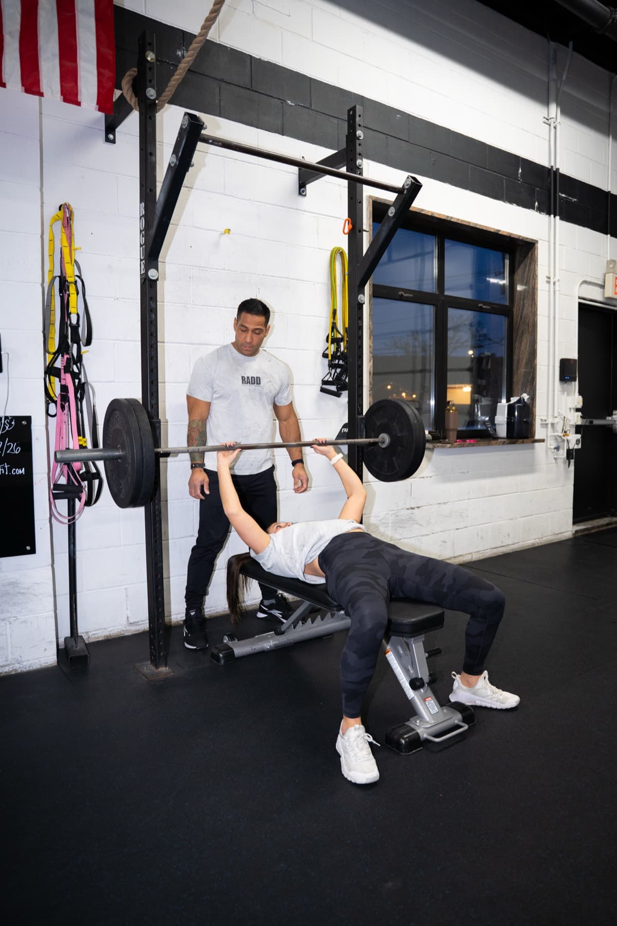 Dan coaching a client through a bench press
